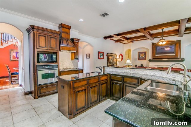 Spacious kitchen with a large wraparound island, granite countertops, and modern appliances at 2365 Lake Forest Drive