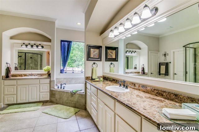 Elegant primary bedroom suite with large windows and comfortable furnishings in the Rockwall custom home