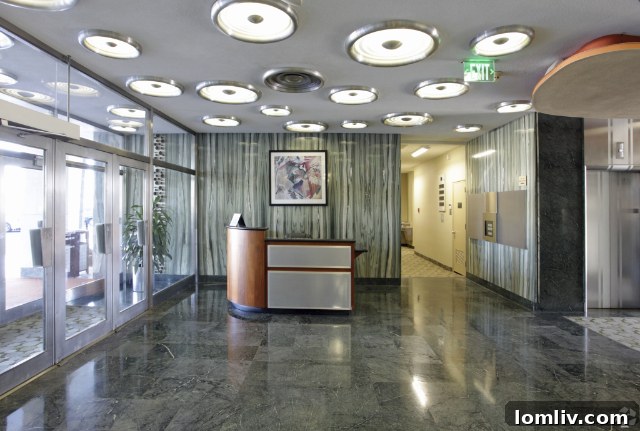 Beautifully updated interior lobby with period-appropriate security desk and electronic directory