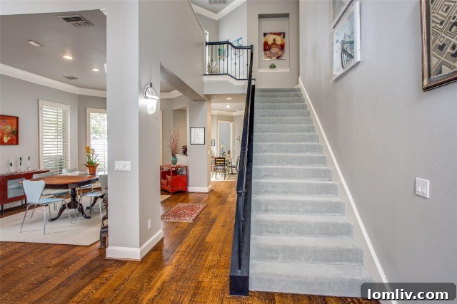 Elegant living room with hand-scraped hardwoods and large windows at 4012 Rawlins Street