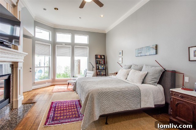 Luxurious primary bedroom suite with fireplace and sitting area at 4012 Rawlins Street