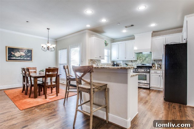 Bright and airy living and dining area with fireplace at 4524 Emerson Avenue #2