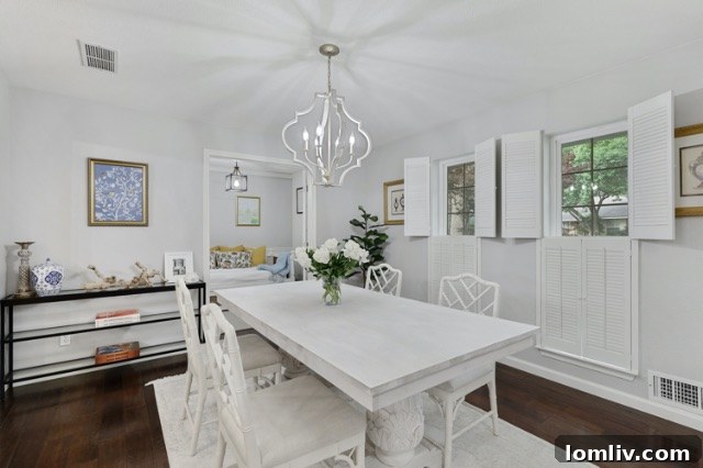 Modern transitional dining room at 8541 Capri Drive after renovation, showcasing new paint and fixtures