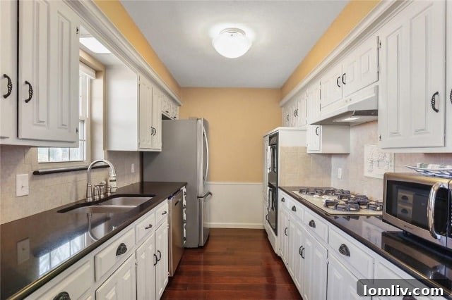 Former kitchen at 8541 Capri Drive with butter yellow walls and original cabinets