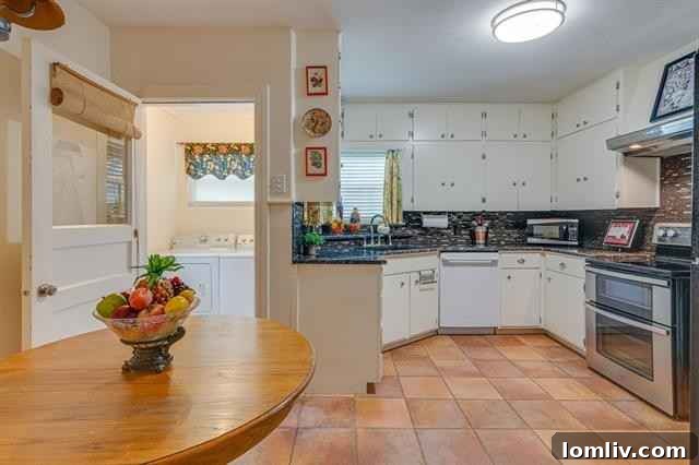 Modernized kitchen with stunning Saltillo tile floors and upgraded appliances in the Oakhurst home, blending rustic charm with functionality