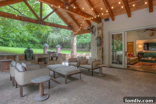 Covered outdoor patio with comfortable seating overlooking the pool in Westover Hills