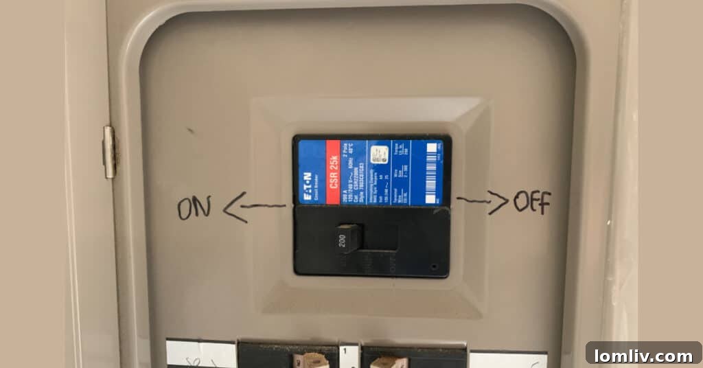 Loose electrical outlet with exposed wiring, indicating a dangerous DIY installation.