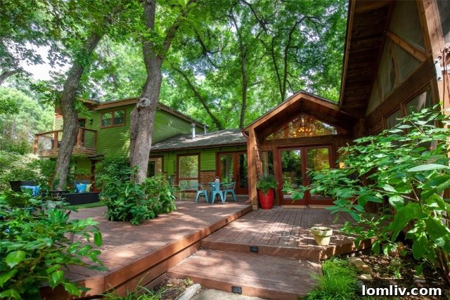 Architectural marvel: Modern rustic home exterior with lush landscaping and expansive grounds in Forest Hills