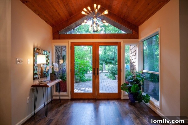 Front exterior of the modern rustic home showcasing cedar accents and green siding