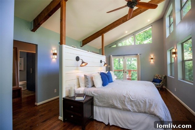 Cozy living area featuring a solid rock fireplace and unique tree branch inspired staircase railing