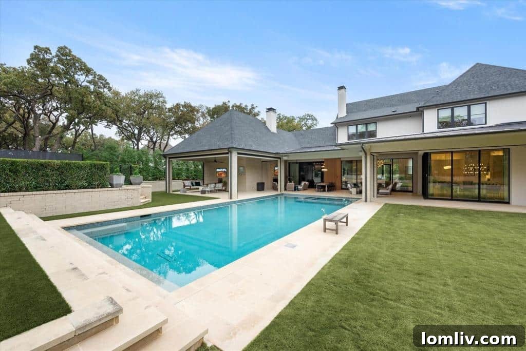 Spacious outdoor living area with a covered patio, fans, and comfortable seating