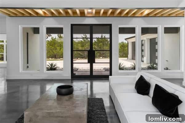 Bright and expansive open concept living area with panoramic windows in modern Fort Worth luxury home
