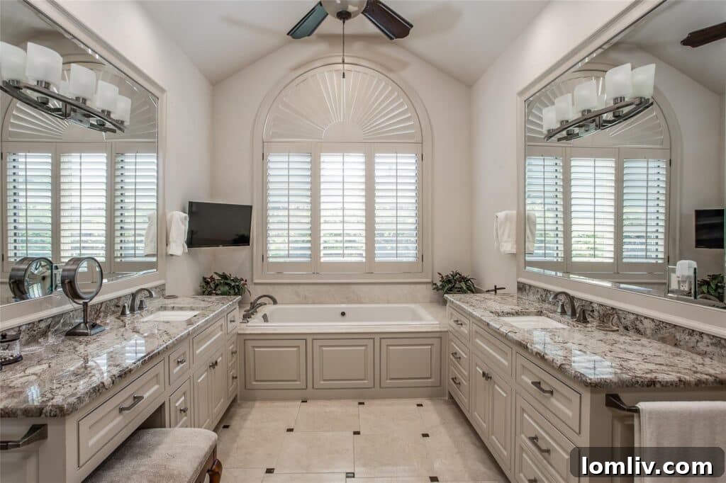 Luxurious primary bathroom featuring intricate marble patterns and custom vanity
