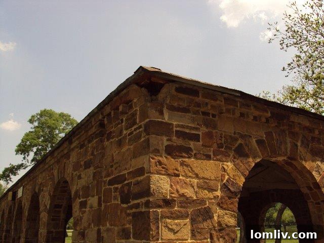 Pre-restoration photo of Stone Pavilion with visible damage