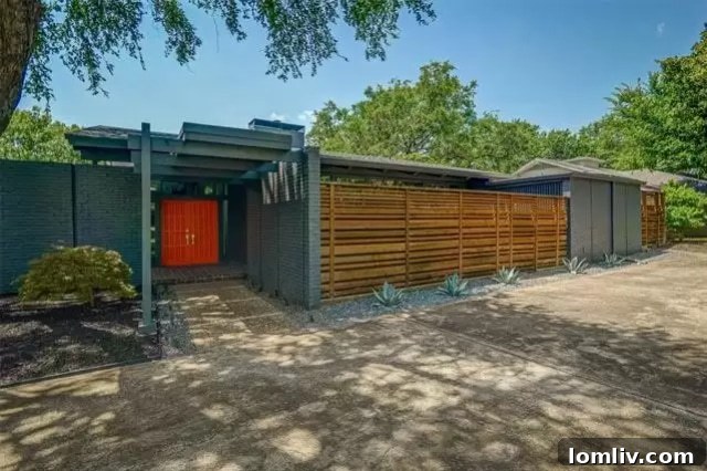 Expansive exterior view of the midcentury modern ranch home at 7358 Fieldgate Drive, Dallas