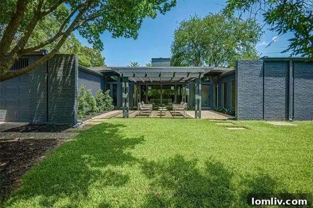 Rear exterior of the home, showing the secure electric gate providing access to the garage from the alley