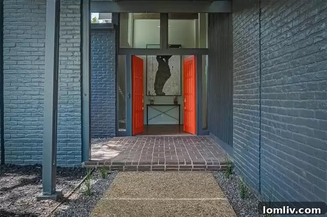 Inviting front facade showcasing the classic lines of the renovated midcentury modern ranch at 7358 Fieldgate Drive