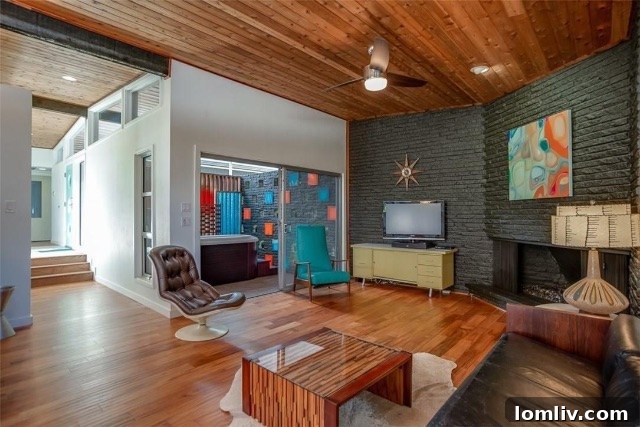 Sun-Drenched Dining Area with Retro Lighting Fixture and Art