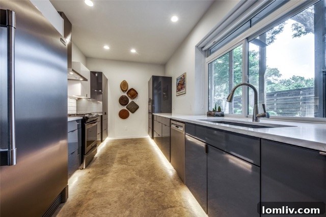 Dining area with modern lighting and polished concrete floors in an open concept home