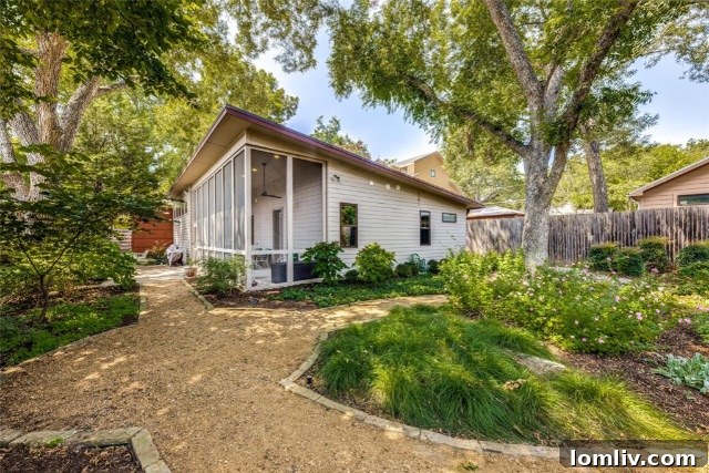 Screened-in porch offering an outdoor living space, part of a sustainable Dallas home