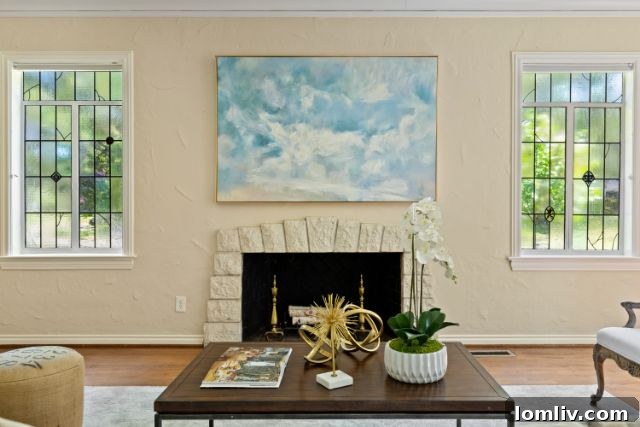 Luxurious Living Room with Stone Fireplace and Ample Natural Light
