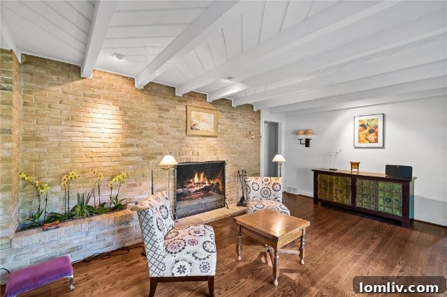 Detail of a rustic stone fireplace with a built-in planter featuring lush greenery