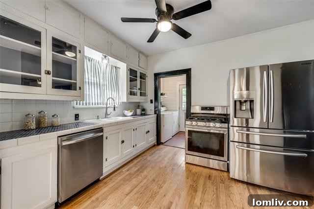 Updated Kitchen with Original Cabinets, Glass Doors, and Modern Refrigerator