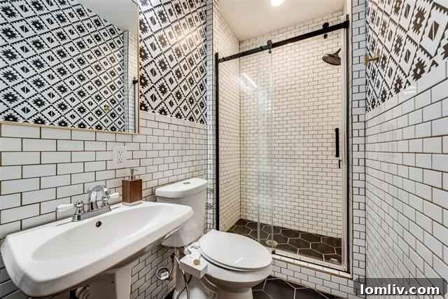 Modernized Bathroom with Black and White Tile Scheme and Updated Fixtures