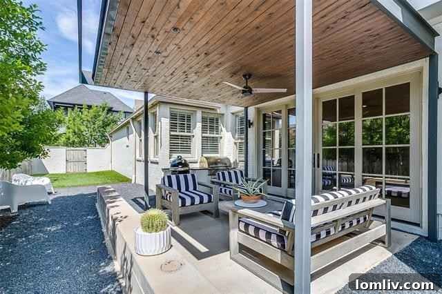 The charming pergola with a ceiling fan creates an ideal outdoor living area, perfect for enjoying the low-maintenance backyard at 2516 Sandage Avenue.