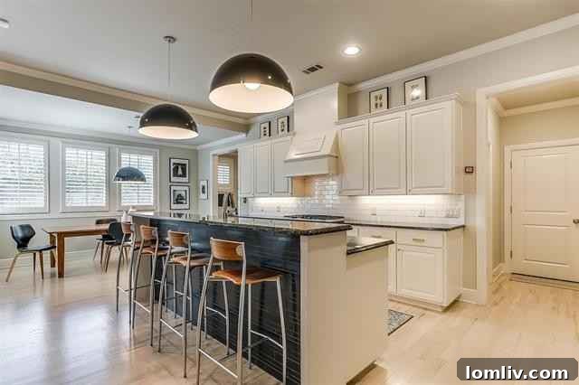 The open-concept living area at 2516 Sandage Avenue features a gas log fireplace, seamlessly connecting to the island kitchen.