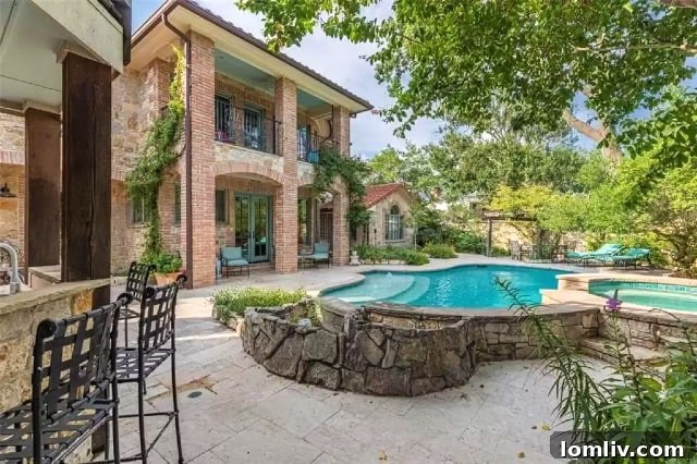 Indulge in resort-style living at 7130 Brookcove Lane with its expansive backyard oasis, lush gardens, and custom pool and spa.