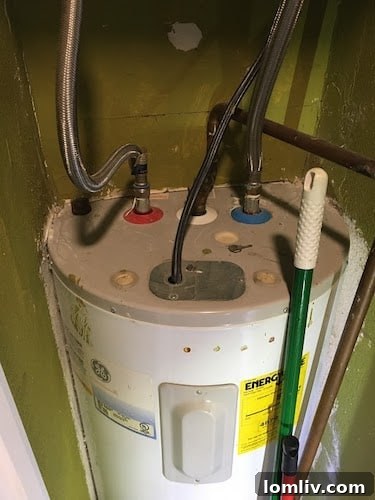 Water heater partially enclosed or recessed into a wall, showing an unusual and potentially unsafe installation practice