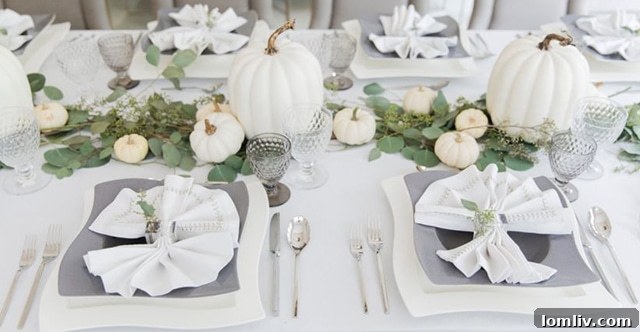 Modern Thanksgiving table with white pumpkins and eucalyptus