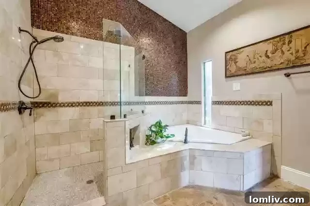 Spacious en-suite primary bathroom with well-maintained tile work and a luxurious jetted tub