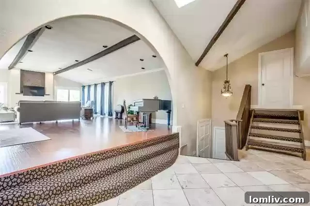 Interior view of the spacious great room at 816 Shadyridge Drive, featuring a grand piano and classic Spanish-style archway