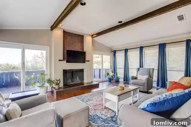 The bright and airy living room at 816 Shadyridge Drive, featuring a modern fireplace and stunning views