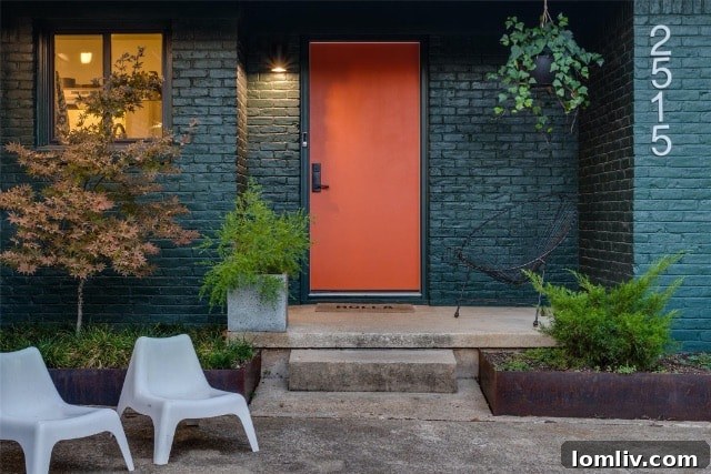 Serene Kiestwood ranch home exterior with deep gray-green brick and vibrant orange door