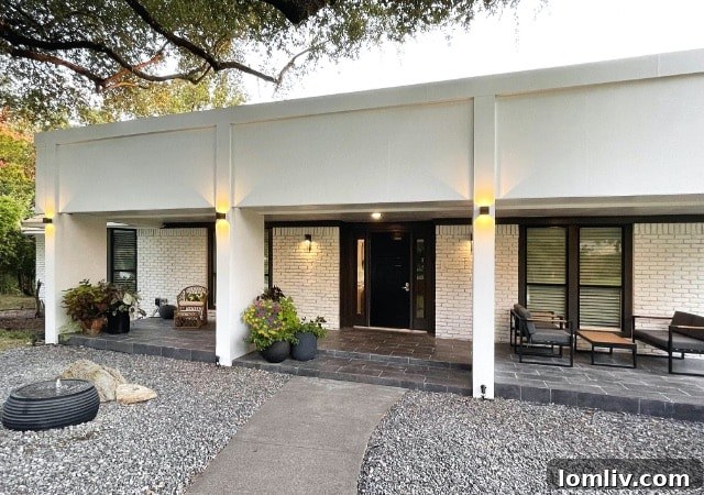 Modern home entrance with water feature and gravel landscaping