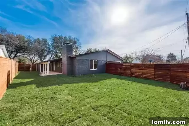 Spacious backyard with a covered patio, ready for personalized landscaping or a pool.