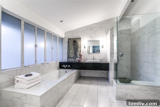 Guest bathroom with shallow, floor-to-ceiling storage shelves