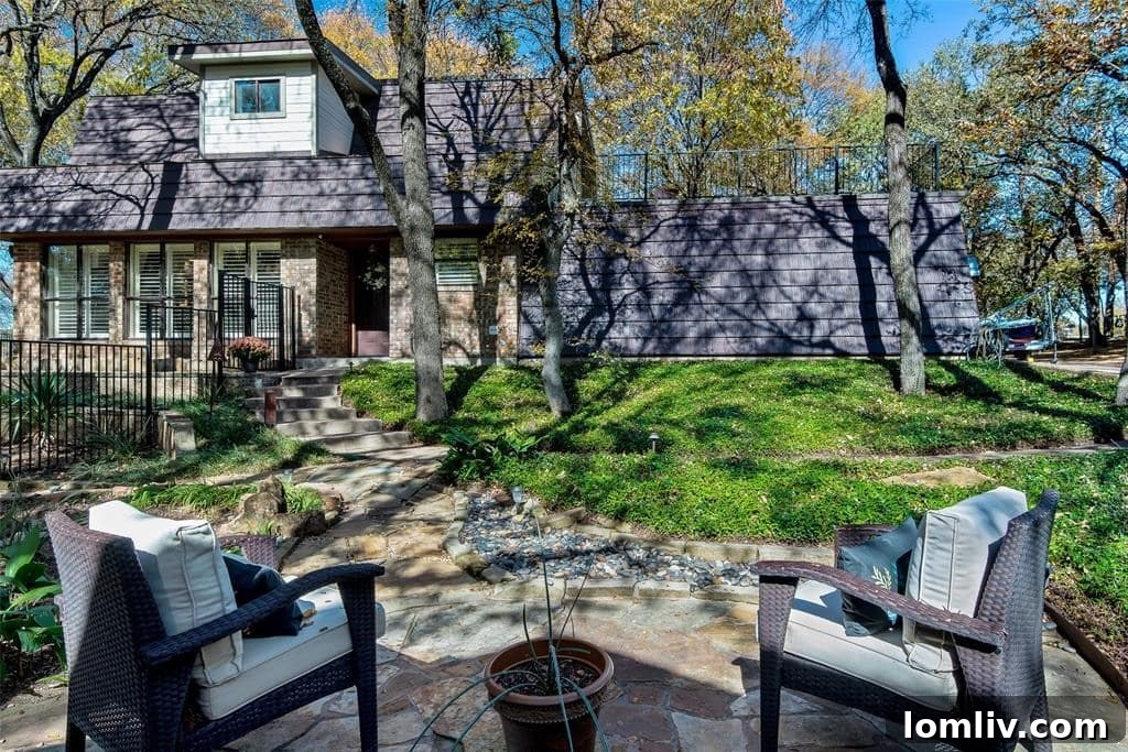 Expansive outdoor patio with fire pit and lush trees
