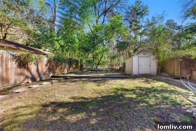 Large, private backyard of a Tudor home, backing onto a natural treeline