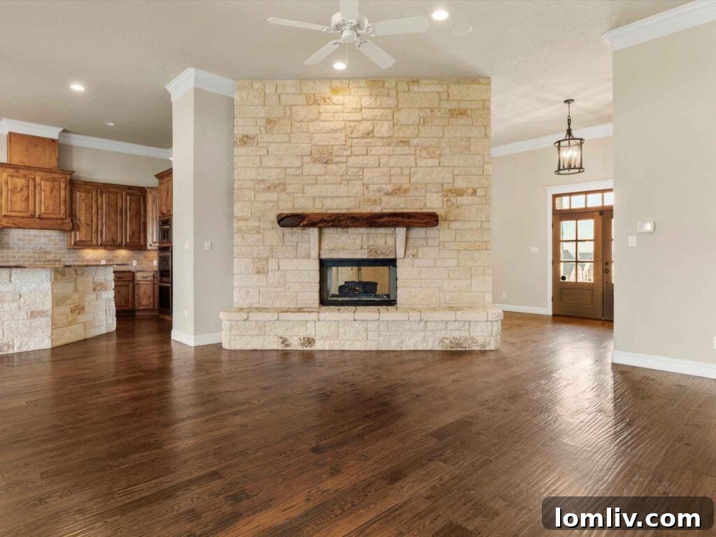 Open concept living area with native Texas stone accents and abundant natural light