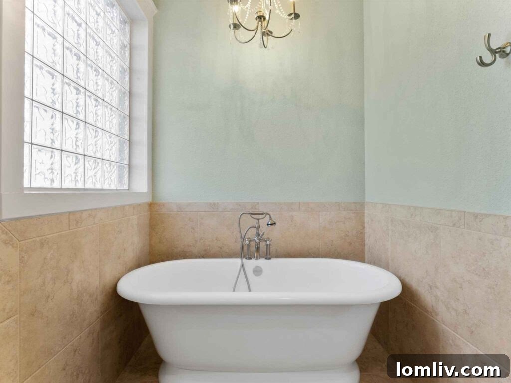 Luxurious primary bathroom with twin sinks, modern fixtures, and ample counter space