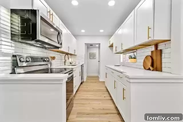 High-Contrast Cottage Adds Funk to Little Forest Hills 6 Bright and Modern Galley Kitchen with Backsplash Window
