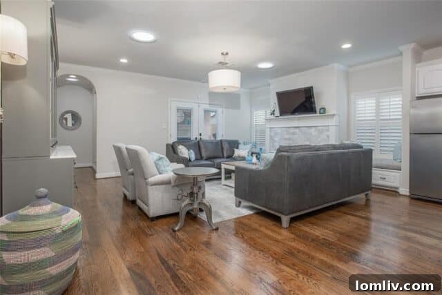 Living room with vintage-style hardwood floors and stone fireplace