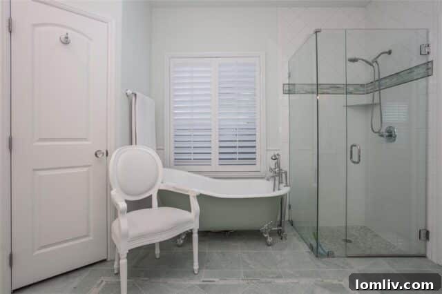 Elegant master bathroom with slipper tub and stone floor