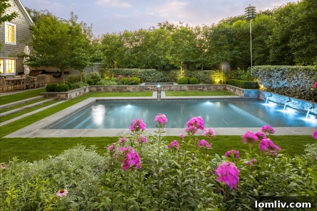 A grand, meticulously landscaped entranceway featuring striking architectural plants, elegant lighting, and a well-defined pathway, embodying welcoming curb appeal
