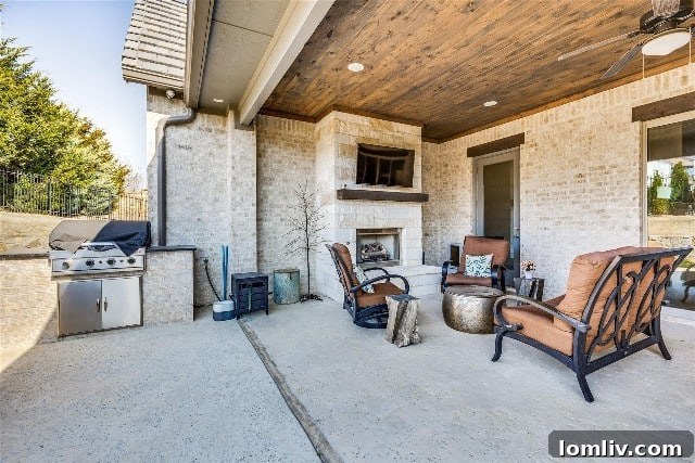 Expansive and inviting covered patio with fireplace and custom grill.