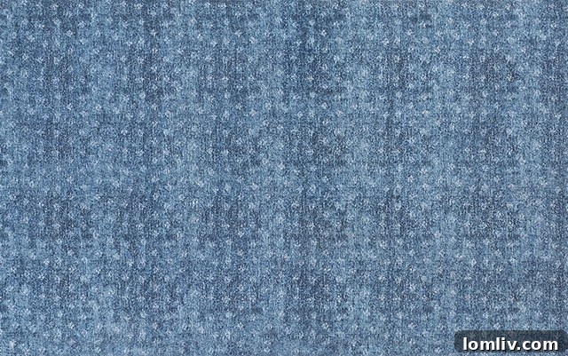 Raindrop Refresh: Elevating Your Home with Spring Style 9 Burrow's Scattered Shower Rug made of 100% recycled fiber, featuring a freeform spot pattern in blue tones.
